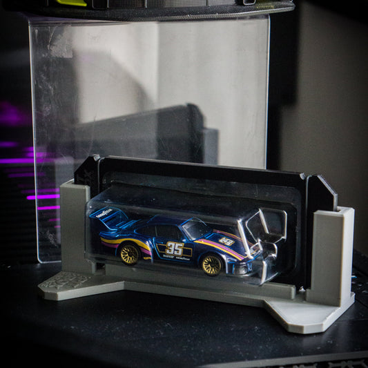 Model car in a display case with a dark background